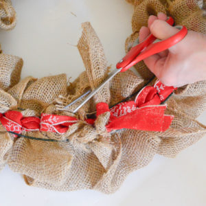 This Christmas burlap wreath is the perfect way to add some rustic charm to your home for the holiday season! It screams Farmhouse and is super budget-friendly! Pop over to get all of the details on how to make one yourself!